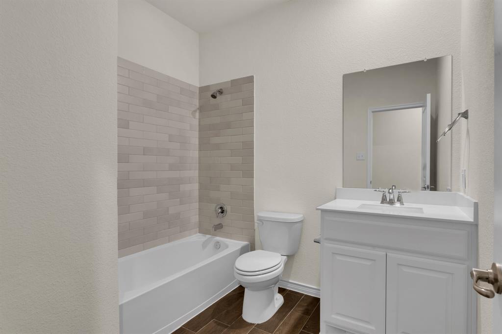 3106 Maverick Drive Forney, TX 75126 - Photo 23 of 29 a bathroom with a sink a toilet and shower