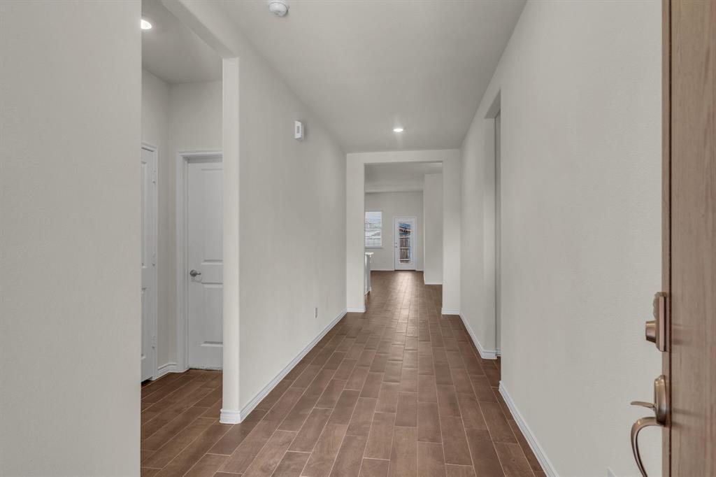 3106 Maverick Drive Forney, TX 75126 - Photo 4 of 29 a view of a hallway with wooden floor