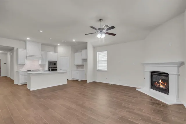 a view of kitchen with sink a microwave and refrigerator