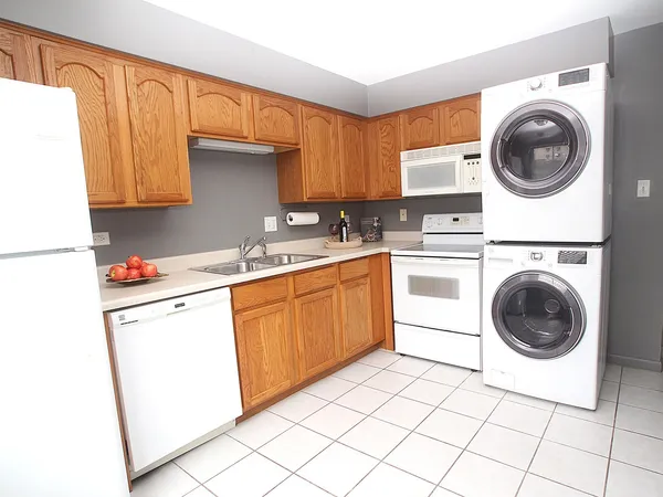 a kitchen with a sink a stove top oven and cabinets