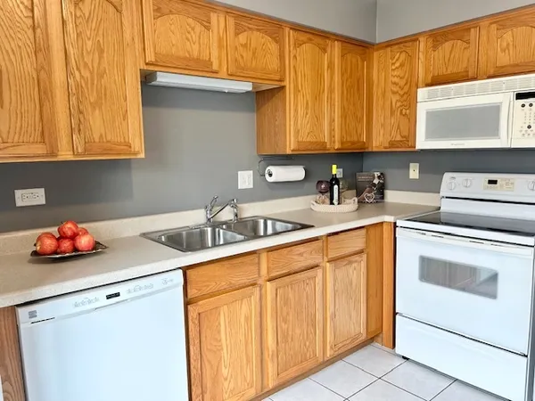 a kitchen with stainless steel appliances a sink stove and cabinets