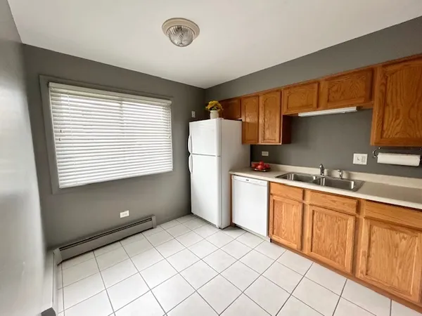 a kitchen with granite countertop a refrigerator and a sink