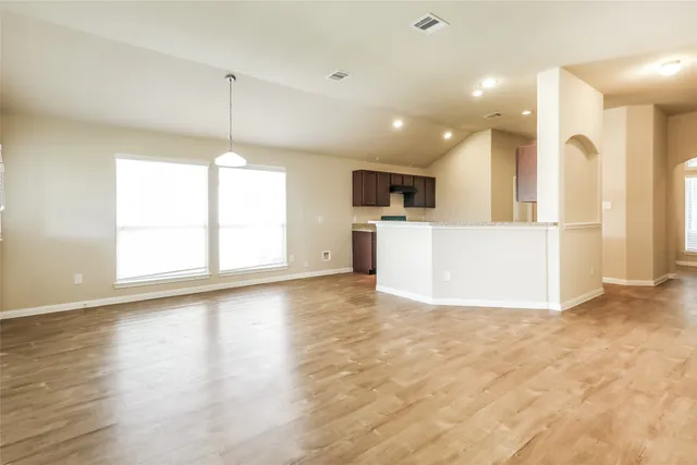 a view of a kitchen with a refrigerator a microwave and a sink