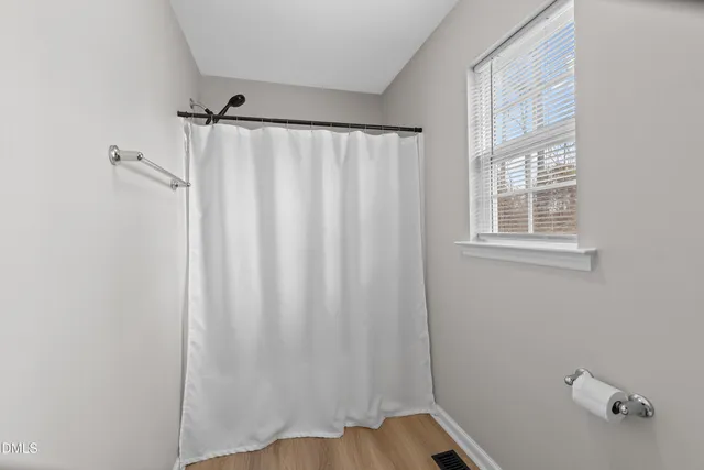 a bathroom with a shower and a window