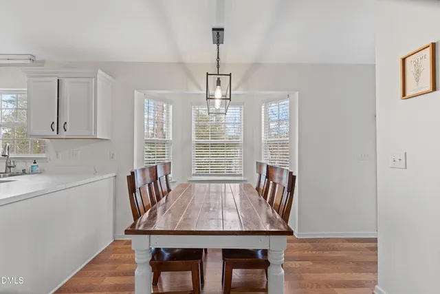 a dining room with a table chairs and entryway