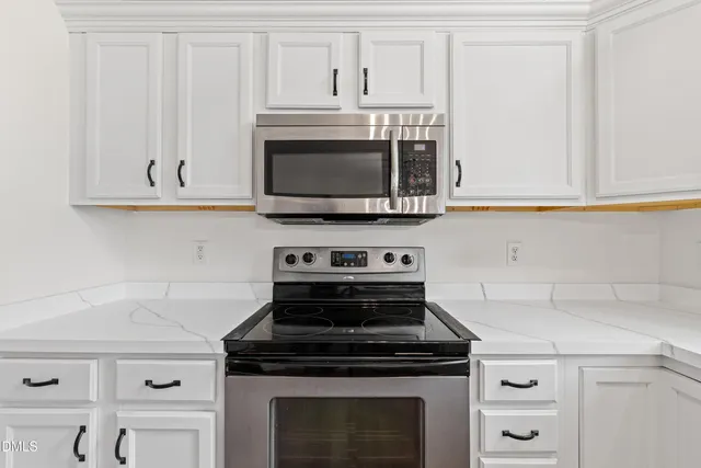 a stove top oven sitting inside of a kitchen