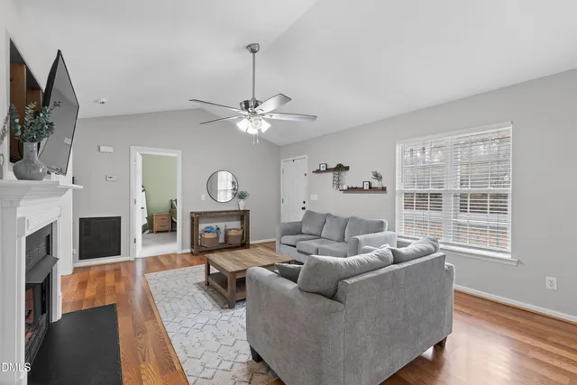 a living room with furniture a fireplace and a flat screen tv