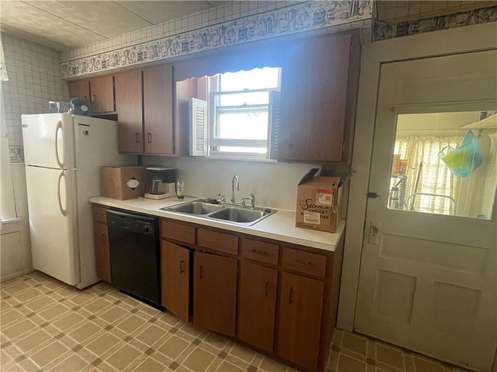 233 East Pine Street Grove City, PA 16127 - Photo 12 of 26 a kitchen with a refrigerator sink and cabinets