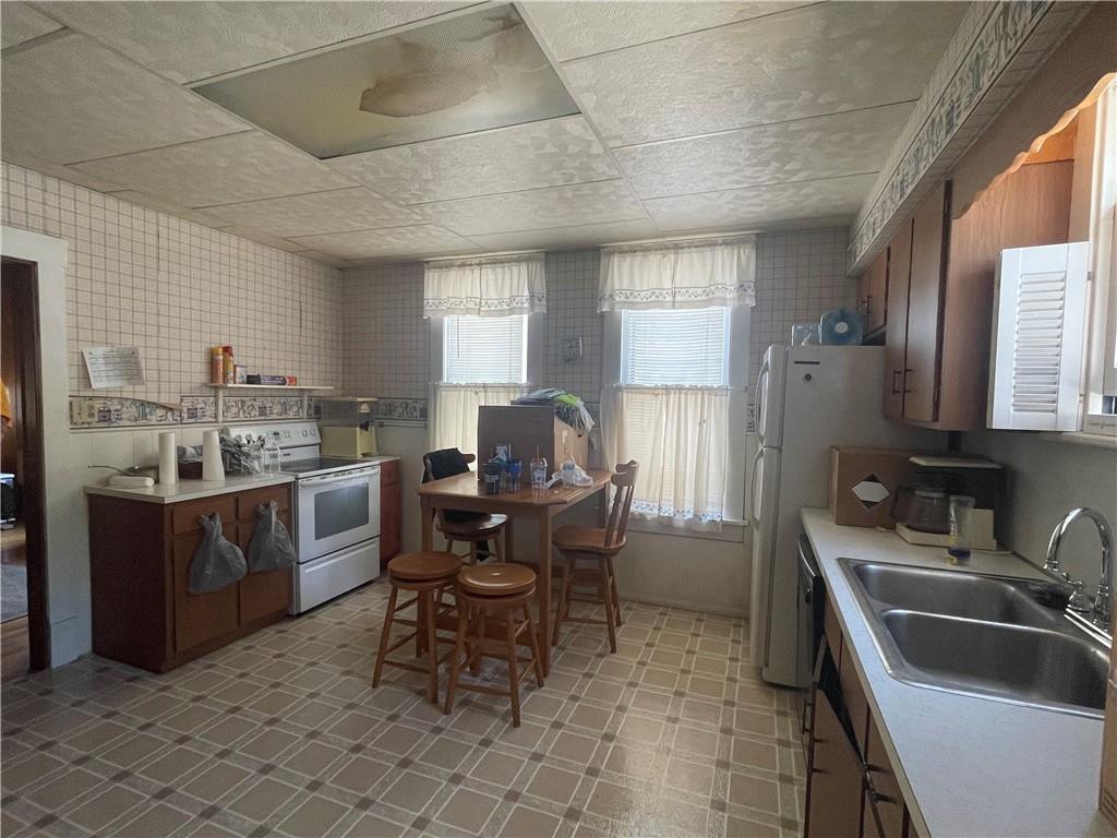 233 East Pine Street Grove City, PA 16127 - Photo 13 of 26 a kitchen with a sink cabinets and appliances