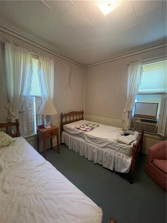 233 East Pine Street Grove City, PA 16127 - Photo 21 of 26 a bedroom with a bed and a chandelier