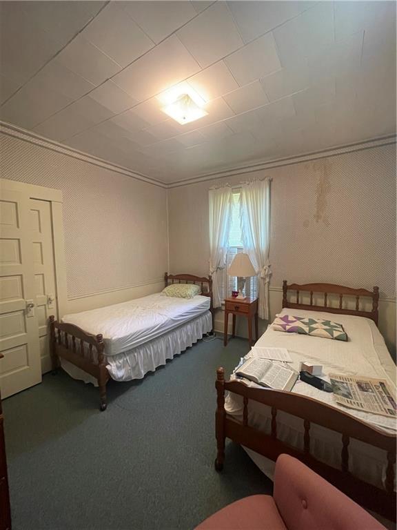 233 East Pine Street Grove City, PA 16127 - Photo 22 of 26 a bed sitting in a bedroom next to a window