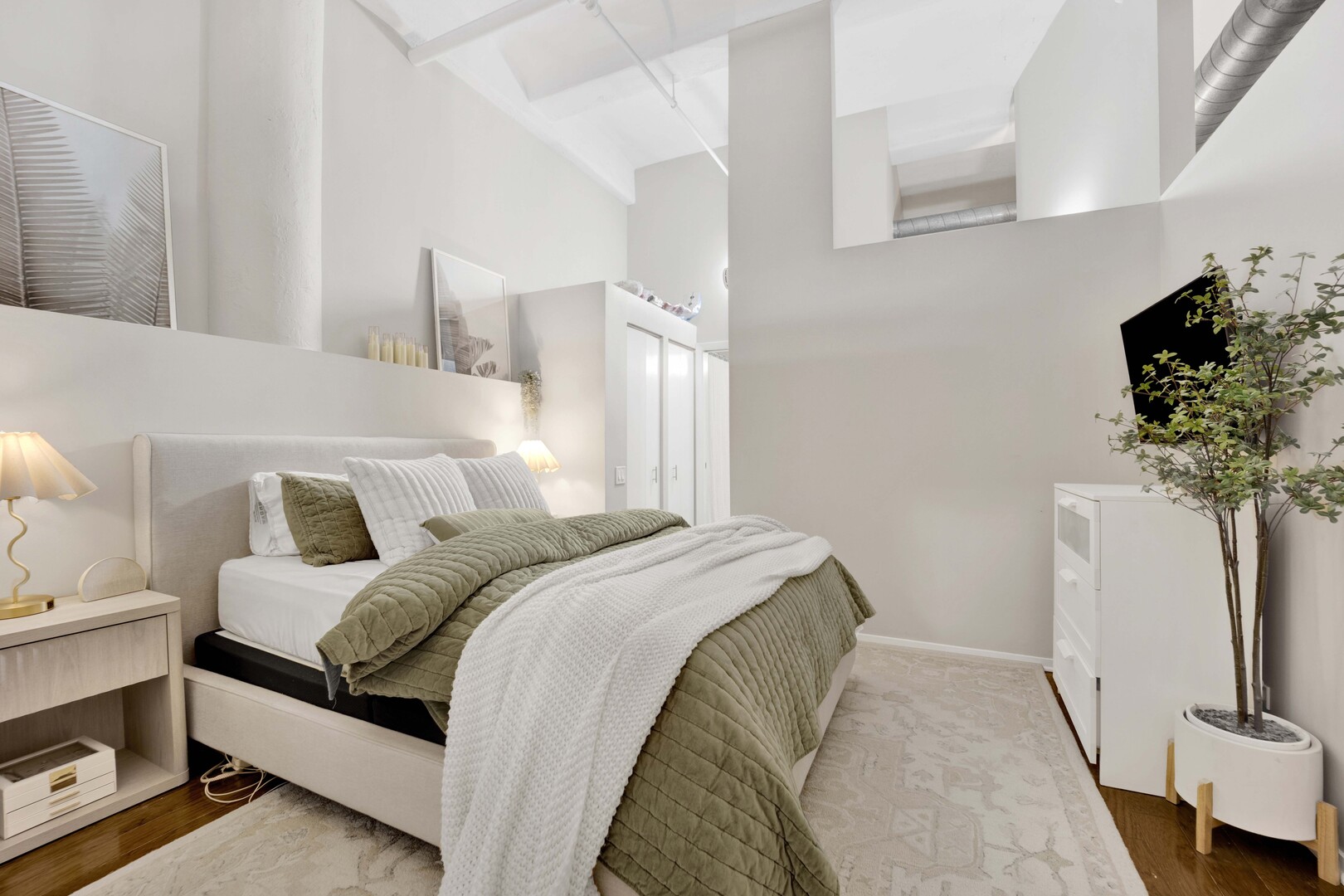 1000 West Washington Boulevard, Unit 305 Chicago, IL 60607 - Photo 15 of 21 a bed room with a bed and a potted plant