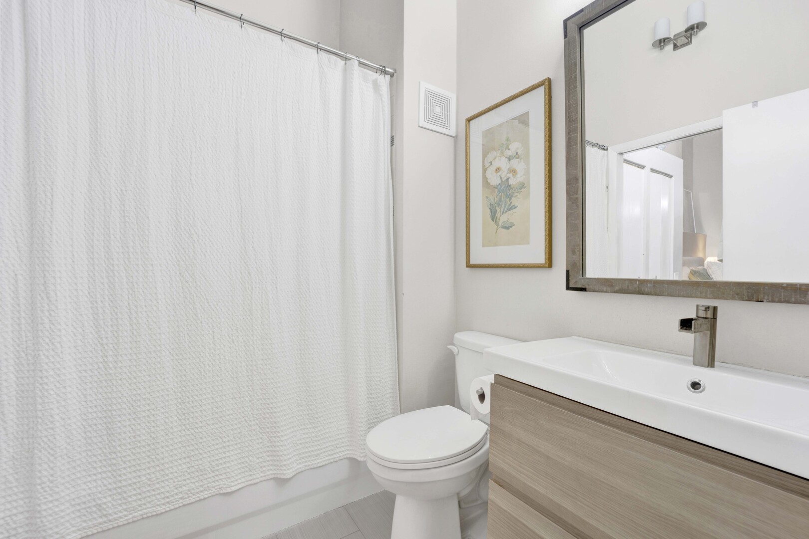 1000 West Washington Boulevard, Unit 305 Chicago, IL 60607 - Photo 17 of 21 a bathroom with a sink toilet and a mirror
