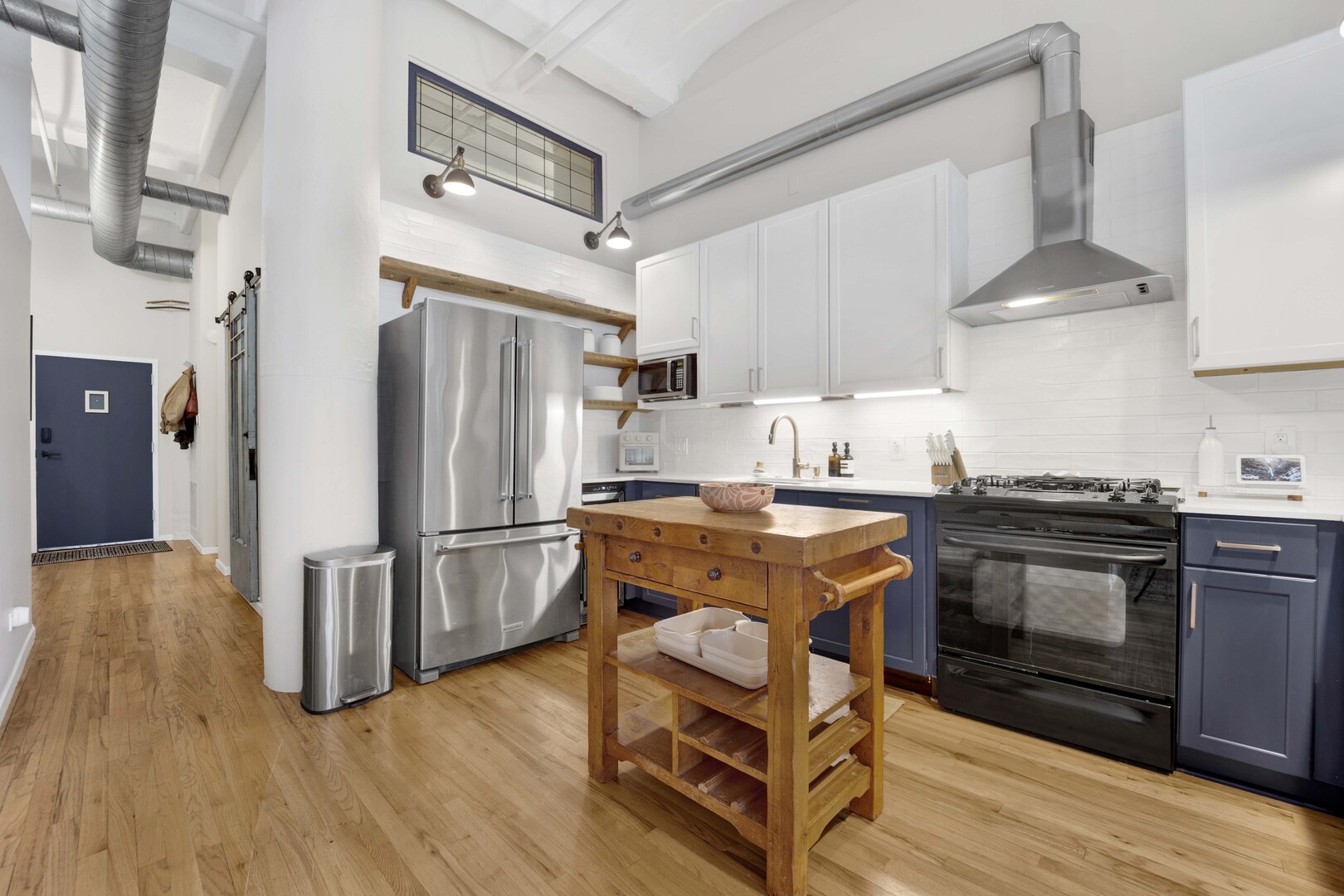 1000 West Washington Boulevard, Unit 305 Chicago, IL 60607 - Photo 5 of 21 a kitchen with stainless steel appliances granite countertop a refrigerator stove and wooden floor