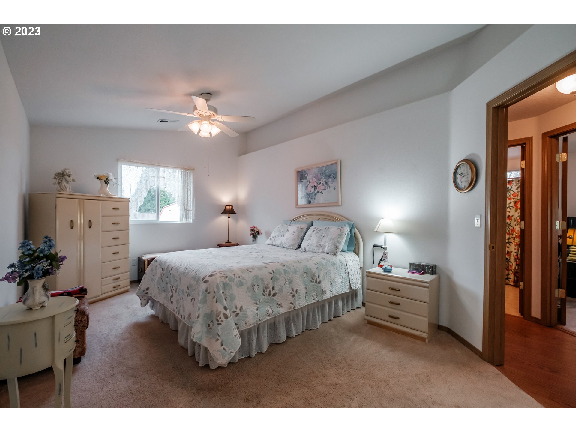 1329 Briar Road Independence, OR 97351 - Photo 13 of 27 a spacious bedroom with a bed and a chandelier