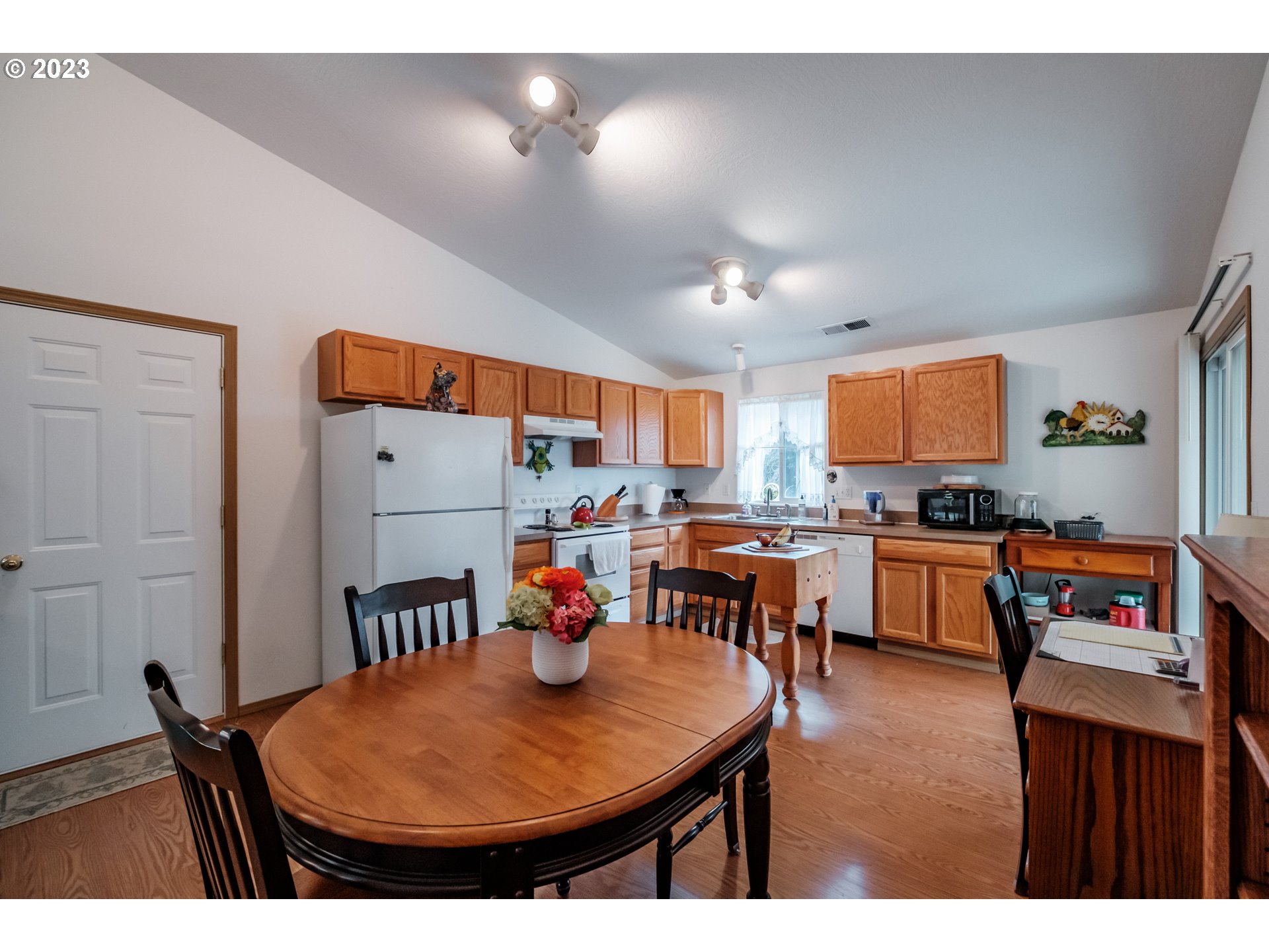 1329 Briar Road Independence, OR 97351 - Photo 17 of 27 a open kitchen with stainless steel appliances granite countertop a sink a stove a dining table and chairs