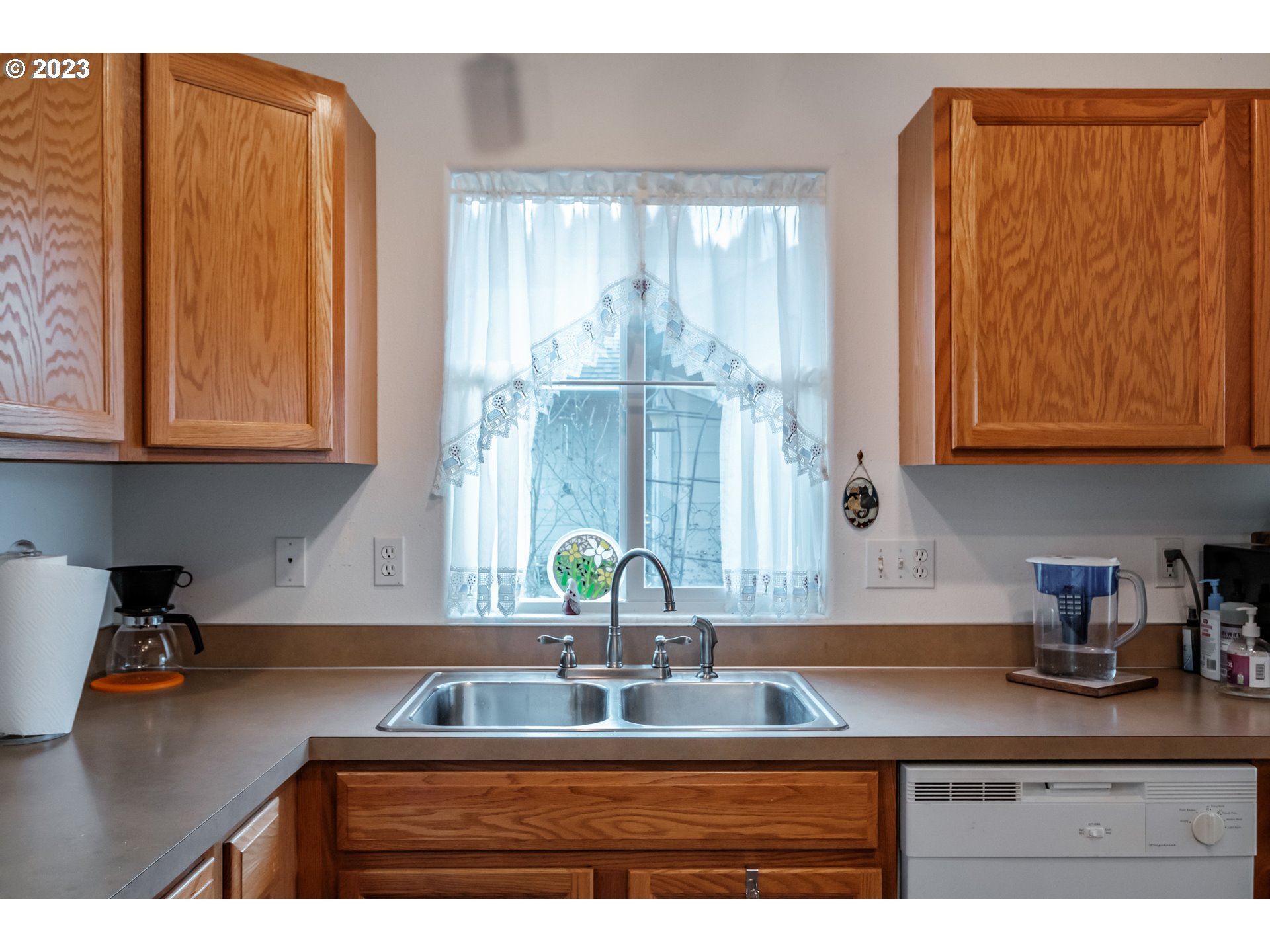1329 Briar Road Independence, OR 97351 - Photo 20 of 27 a kitchen with granite countertop a sink a window and cabinets