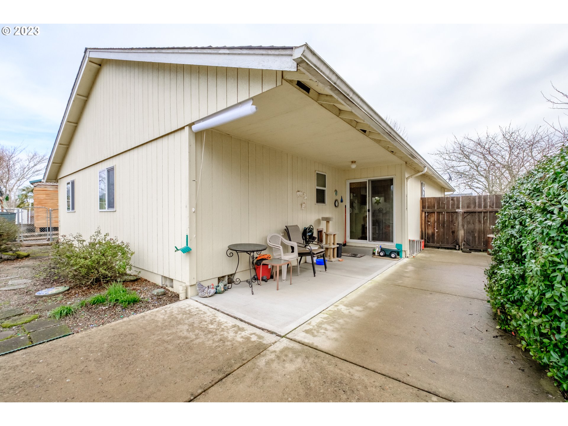1329 Briar Road Independence, OR 97351 - Photo 22 of 27 a view of a patio with dining table and chairs under an umbrella