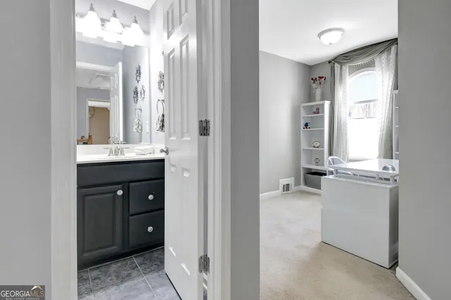 a bathroom with a sink vanity and a mirror