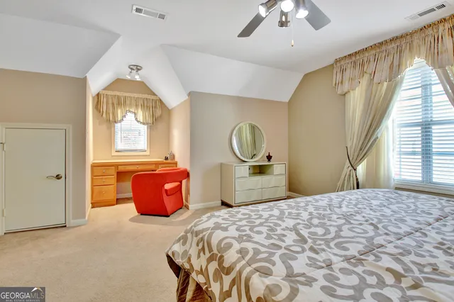 a spacious bedroom with a bed and a chandelier