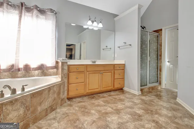 a view of walk in closet with clothes