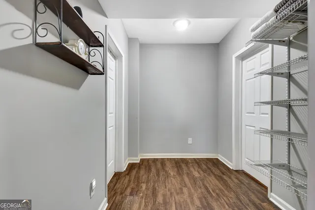 a bedroom with two beds and a book shelf
