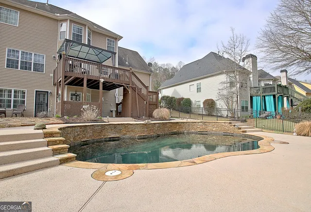 a swimming pool with outdoor seating and yard