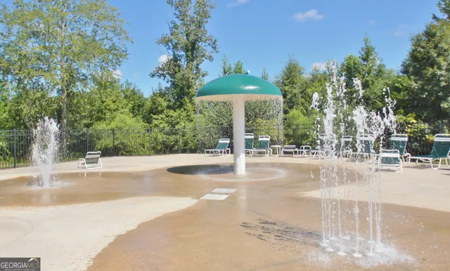 a view of a swimming pool with a garden and trees
