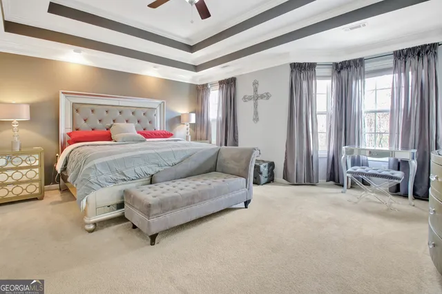 a bedroom with a bed couch and a window