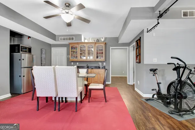 a view of a dining room with furniture and a chandelier