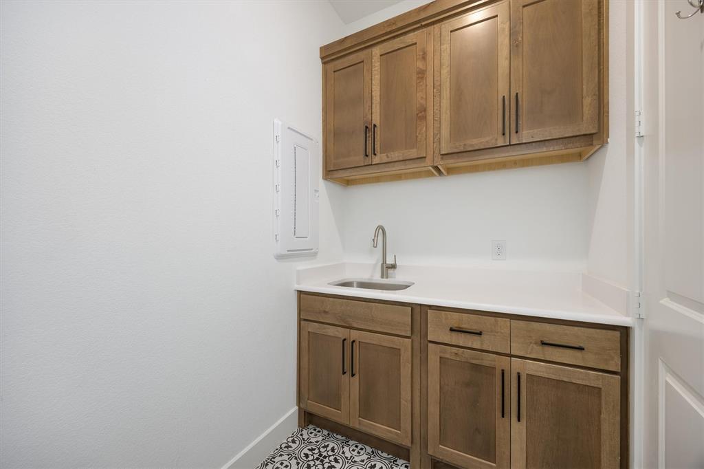 1303 Limestone Ridge Road Mansfield, TX 76063 - Photo 23 of 34 The Knotty Alder wood is continued in the laundry room...so pretty!