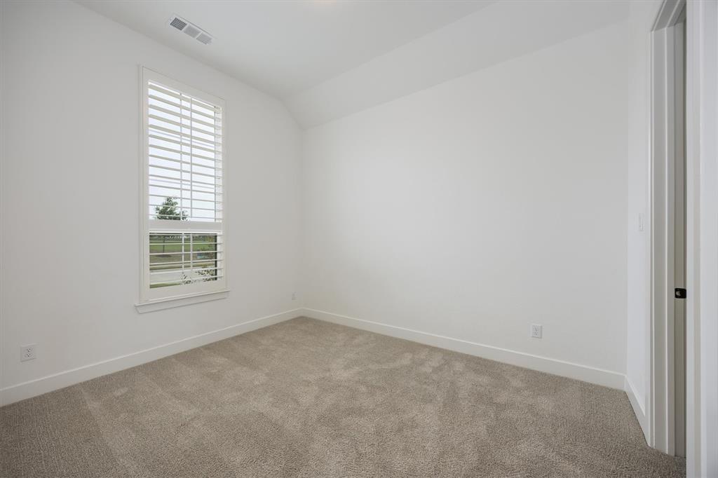 1303 Limestone Ridge Road Mansfield, TX 76063 - Photo 24 of 34 Spacious bedroom located on the back of the house. This bedroom has it's own bath located just outside of the doorway.