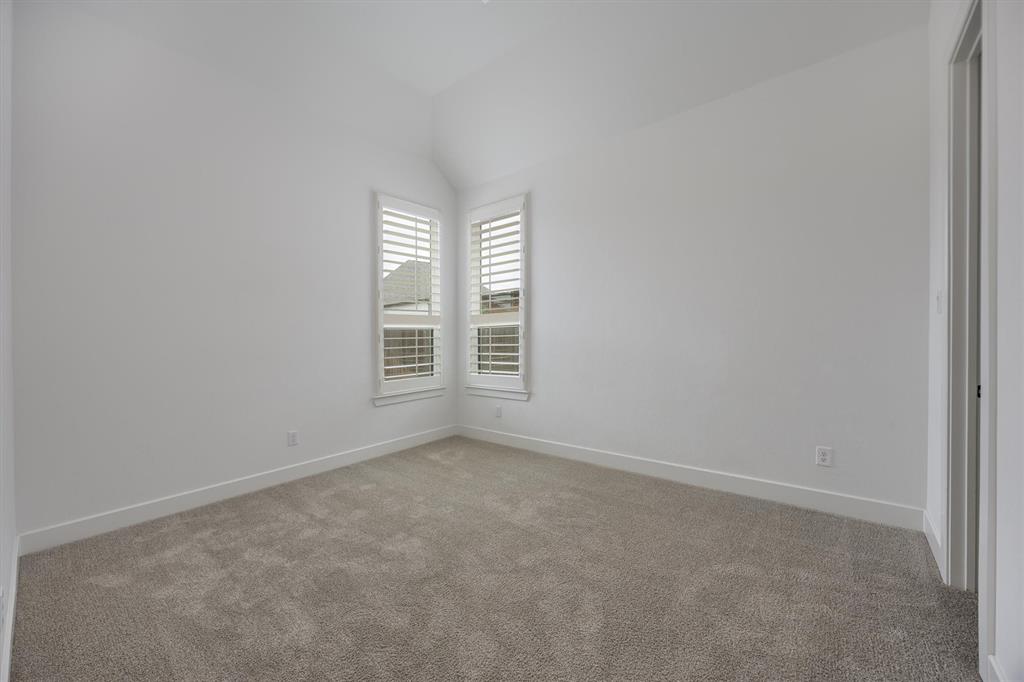 1303 Limestone Ridge Road Mansfield, TX 76063 - Photo 26 of 34 This bedroom has a private bath and is located on the front of the home.