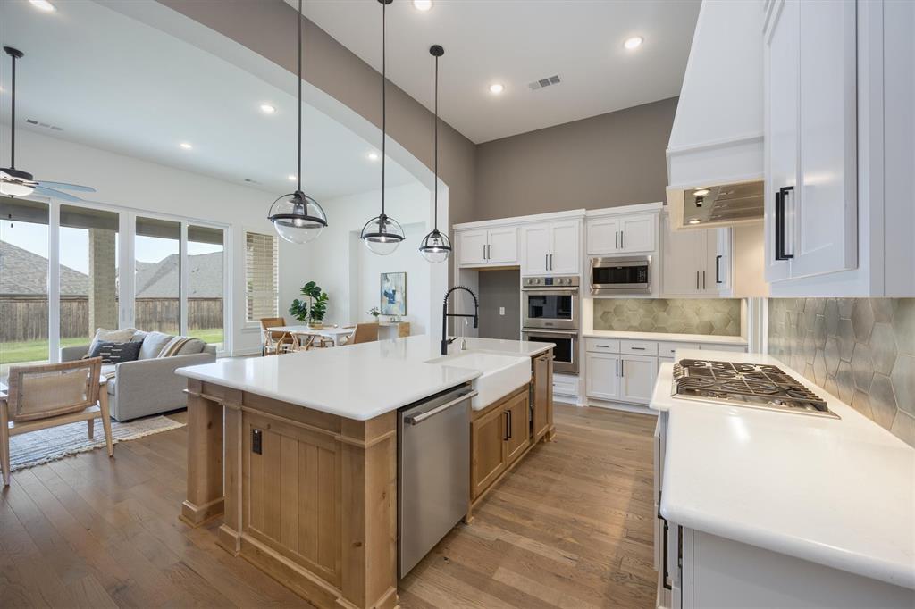1303 Limestone Ridge Road Mansfield, TX 76063 - Photo 7 of 34 Quartz kitchen counters with upgraded Knotty Alder wood island!
