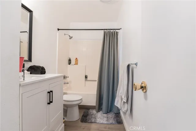 a bathroom with a sink a toilet and a shower