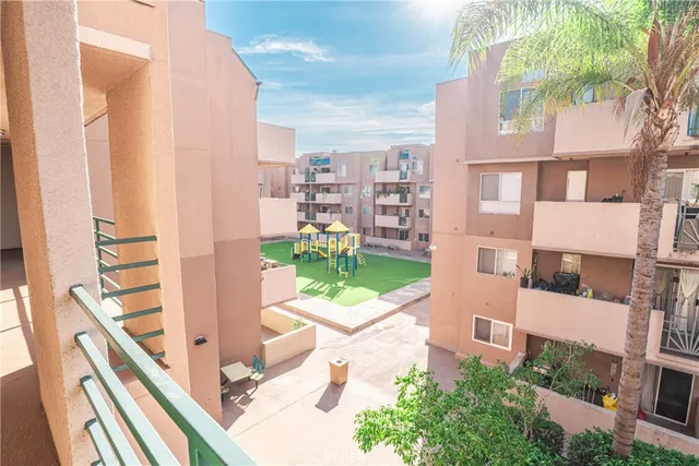 a view of a patio with couches table and chairs and potted plants