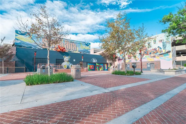 a view of house with backyard and sitting area