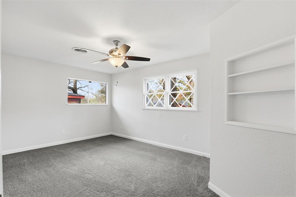 2212 Briardale Road Fort Worth, TX 76119 - Photo 14 of 25 an empty room with windows and ceiling fan