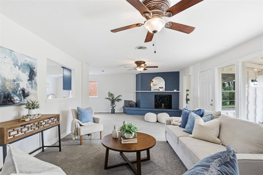 2212 Briardale Road Fort Worth, TX 76119 - Photo 3 of 25 a living room with furniture a rug and a mirror