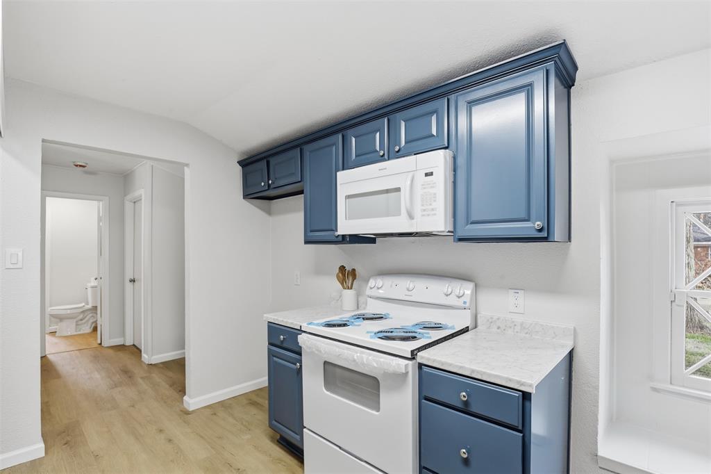 2212 Briardale Road Fort Worth, TX 76119 - Photo 9 of 25 a kitchen with a stove and a microwave