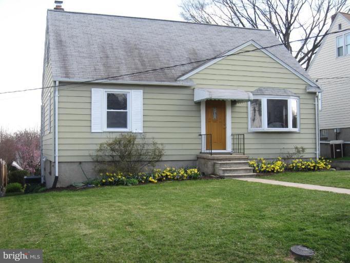 7917 34th Street Rosedale, MD 21237 - Photo 2 of 23 a front view of a house with a garden