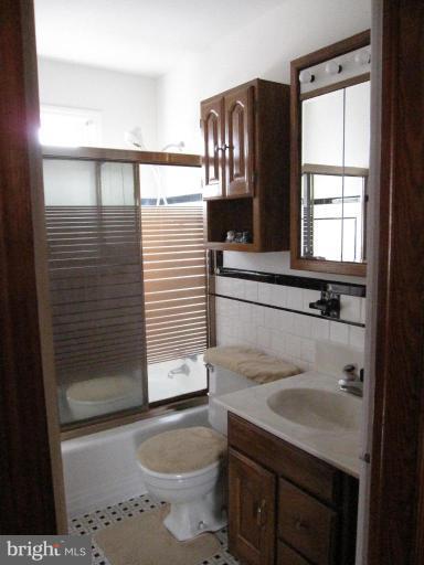 7917 34th Street Rosedale, MD 21237 - Photo 13 of 23 a bathroom with a sink a toilet and shower