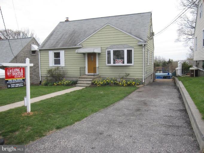 7917 34th Street Rosedale, MD 21237 - Photo 3 of 23 a front view of a house with a garden