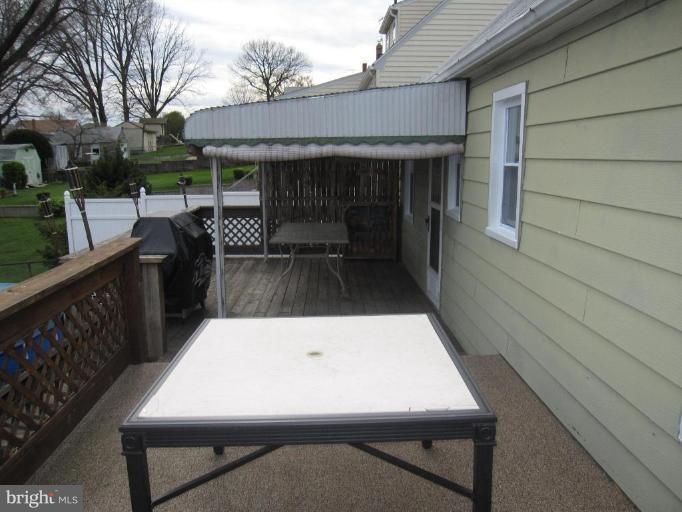 7917 34th Street Rosedale, MD 21237 - Photo 7 of 23 a view of a patio with wooden fence and two chairs