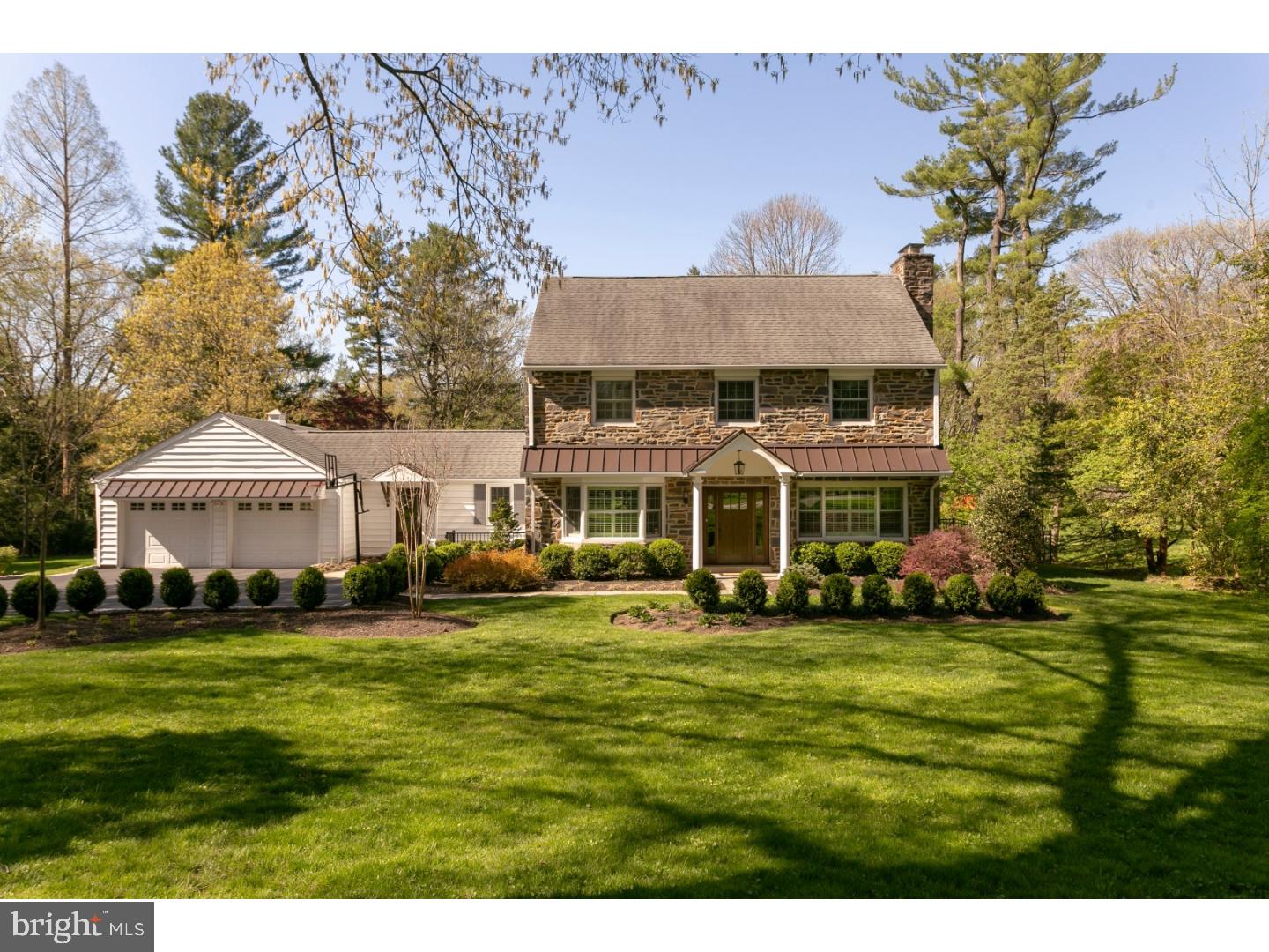 a view of a big house with a big yard and large trees