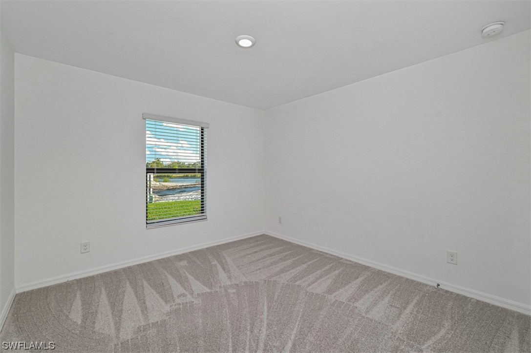 830 General Chesty Puller Court LaBelle, FL 33935 - Photo 17 of 21 an empty room with a window and a wooden floor