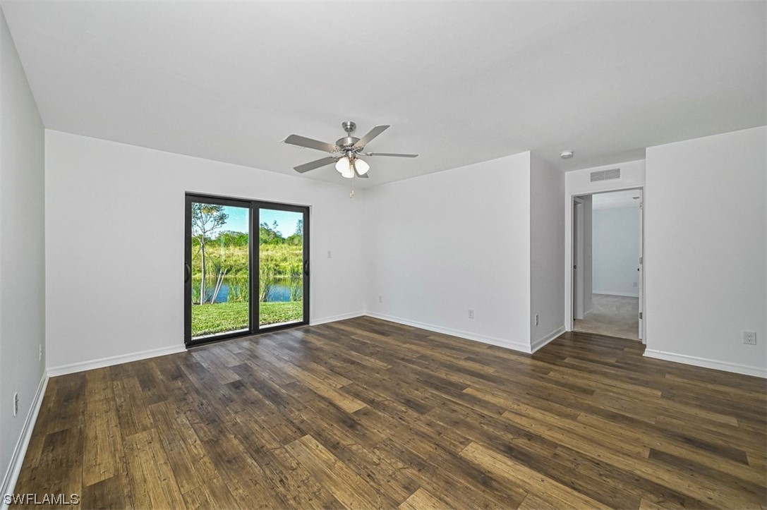 830 General Chesty Puller Court LaBelle, FL 33935 - Photo 4 of 21 a view of an empty room with a window and wooden floor