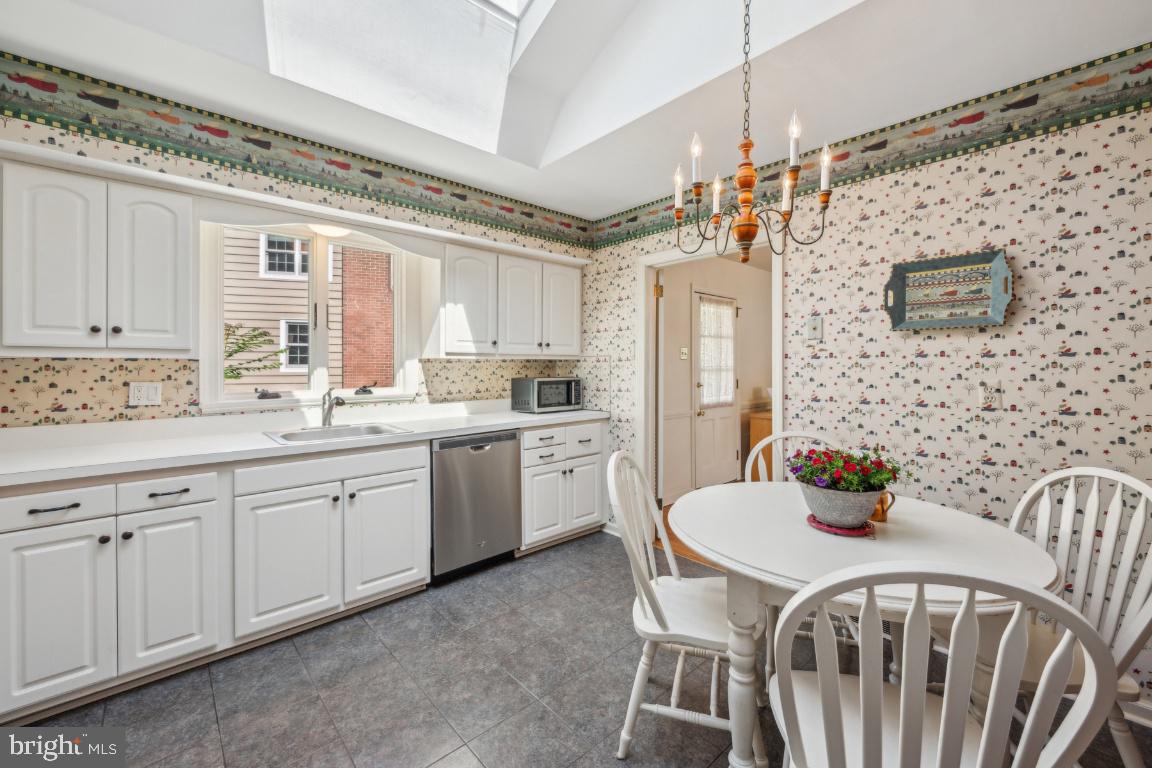 2 Wagon Bridge Run Moorestown, NJ 08057 - Photo 11 of 23 a kitchen with stainless steel appliances a table and chairs in it