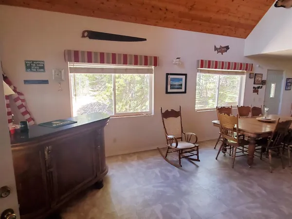 a view of a livingroom with workspace and a window