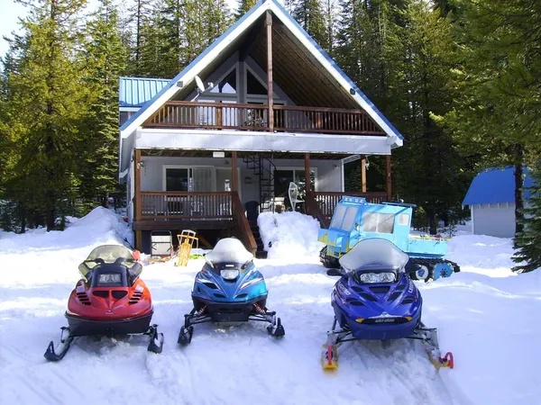 a front view of a house with a yard and lounge chairs